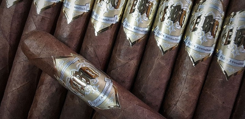 EGO Gold cigars laid side by side under gold and white bands