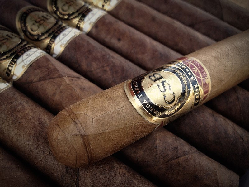CSB cigars in a cedar box, gold medallion bands facing up